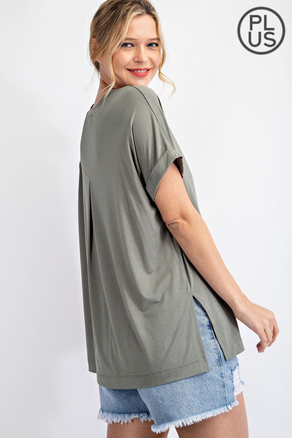 Plus-size V-neck short sleeve Rae Mode top in Latte color
Close-up of back pleat detail and fabric texture
Vintage Denim variant of Rae Mode V-neck plus top, styled with jeans