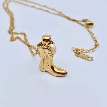 Western Cowgirl Boot Charm Necklace – close-up – Boot-shaped charm pendant on delicate chain.
Western Cowgirl Boot Charm Necklace – flat lay – Necklace displayed with Western-style detailing.
Western Cowgirl Boot Charm Necklace – lifestyle view – Model wearing boot charm necklace styled with casual outfit.
Boot charm detail close-up – Zoomed view of cowgirl boot pendant design.
Western Cowgirl Boot Charm Necklace – styled layering – Boot charm necklace paired with other Western-inspired necklaces