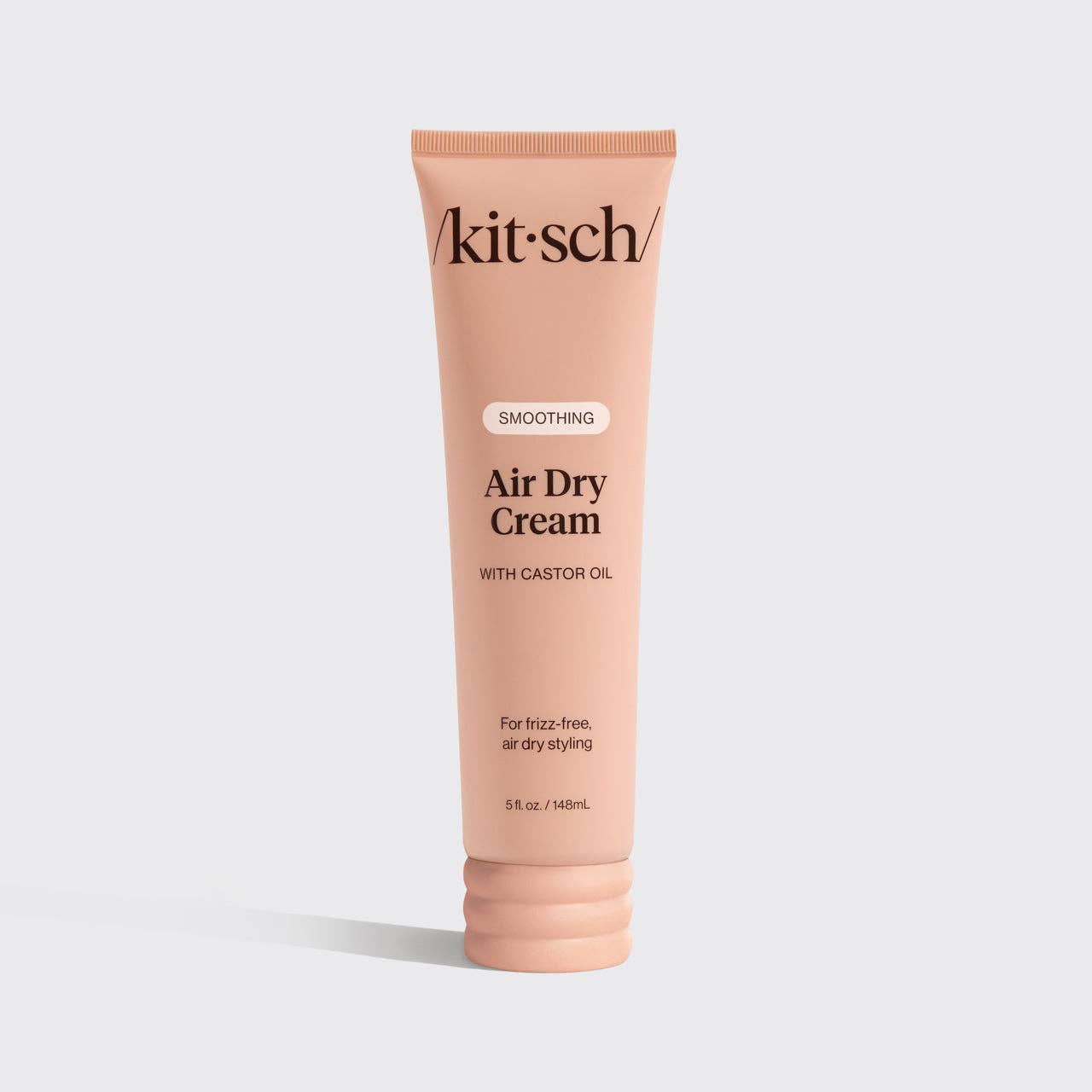 Front view of KITSCH Smoothing Air Dry Cream tube with black cap on white background