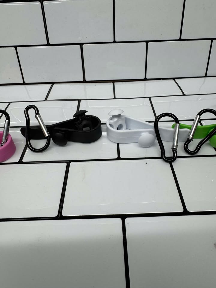 Bogg Bag Hook clipped into Bogg Bag rim holding keys & charm
Close-up of colored snap-in EVA hook in Bogg Bag hole
Multiple hooks displayed in assorted colors beside Bogg Bag
Hook holding AirTag and sunglasses attached to Bogg Bag