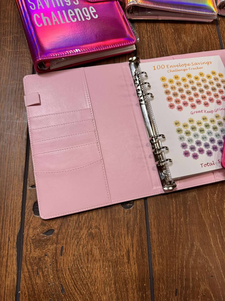 100 Envelope Savings Challenge binder in black with tracker sheet and envelopes
Pastel color binders open to interior pockets and numbered envelope sleeves
Insert pages showing pocketed envelopes and tracker card grid
Stylish stack of multiple-colored savings binders (mint, lavender, pink)
