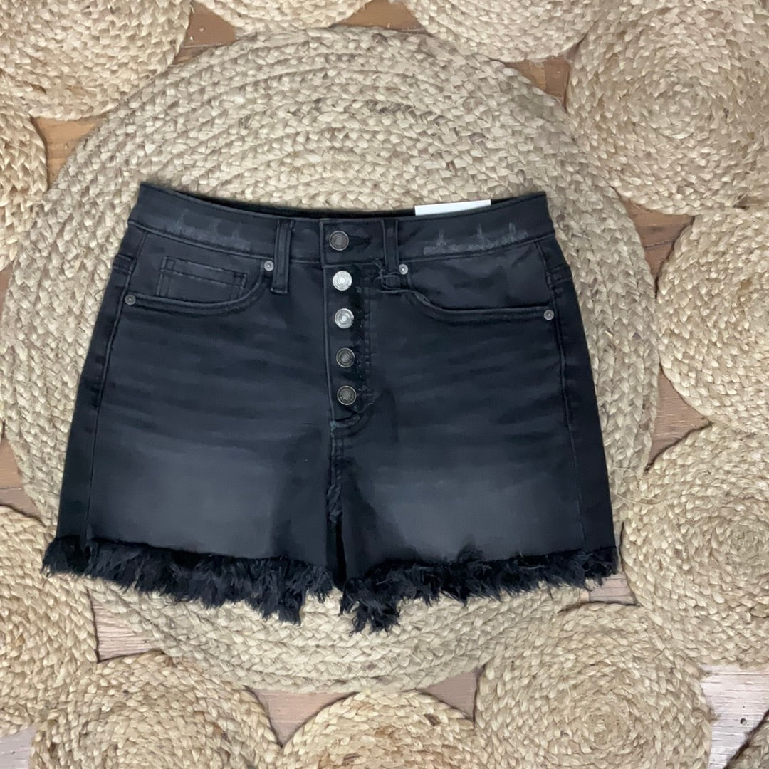 Black denim jean shorts with a high-rise waist and frayed hem laying flat on a surface.