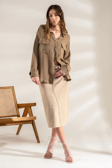 Olive oversized button-down shacket with frayed hem laid flat
Close-up of contrast stitching and chest pocket tab detail
View of raw hem edge and drape of oversized silhouette