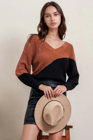 Front view of the Blu Pepper asymmetrical colorblock sweater with V-neck
Close-up of back tie detail & colorblock pattern
Long sleeve view with relaxed fit and knit texture