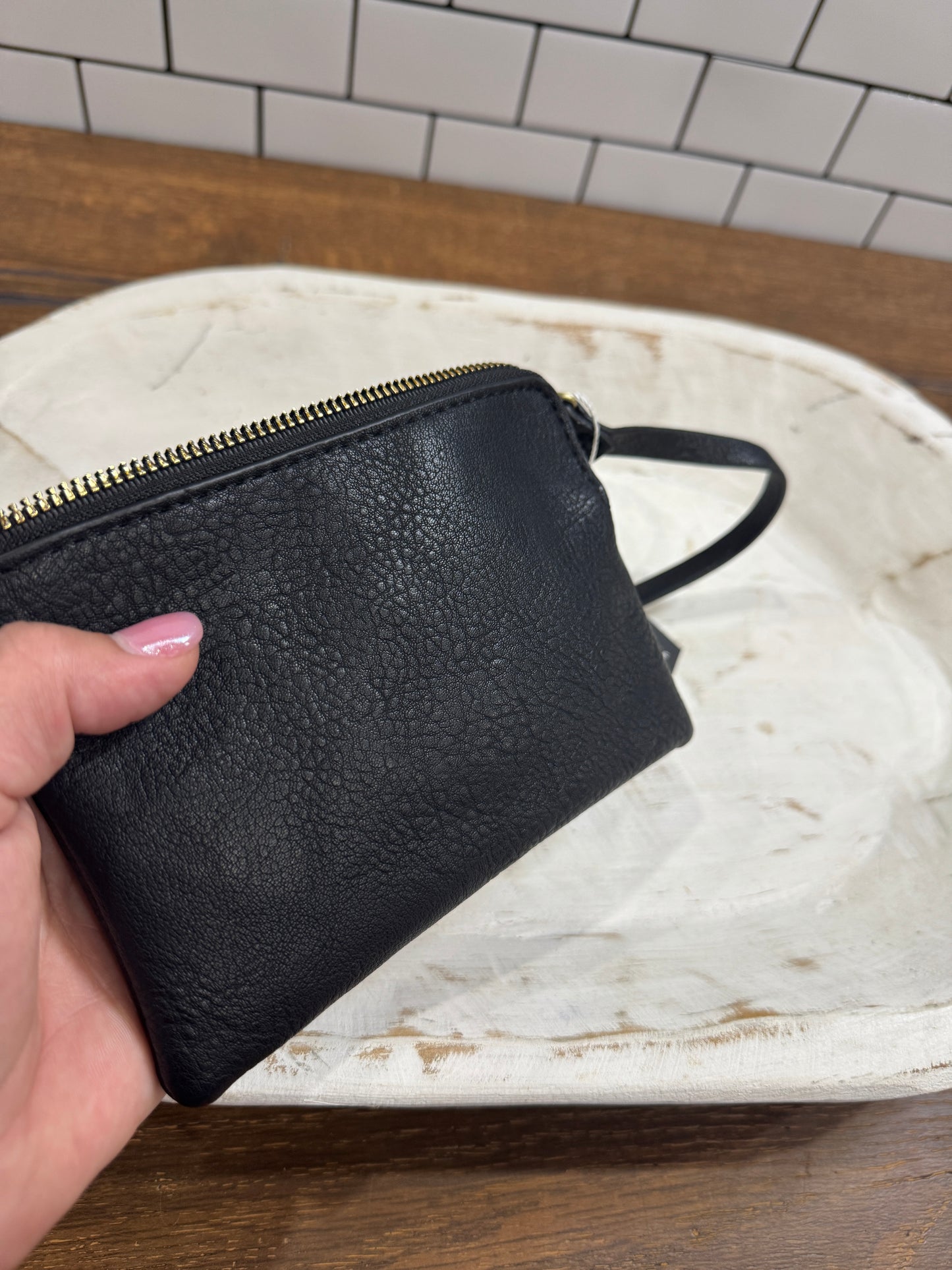 Minimalist black clutch bag with zipper and strap