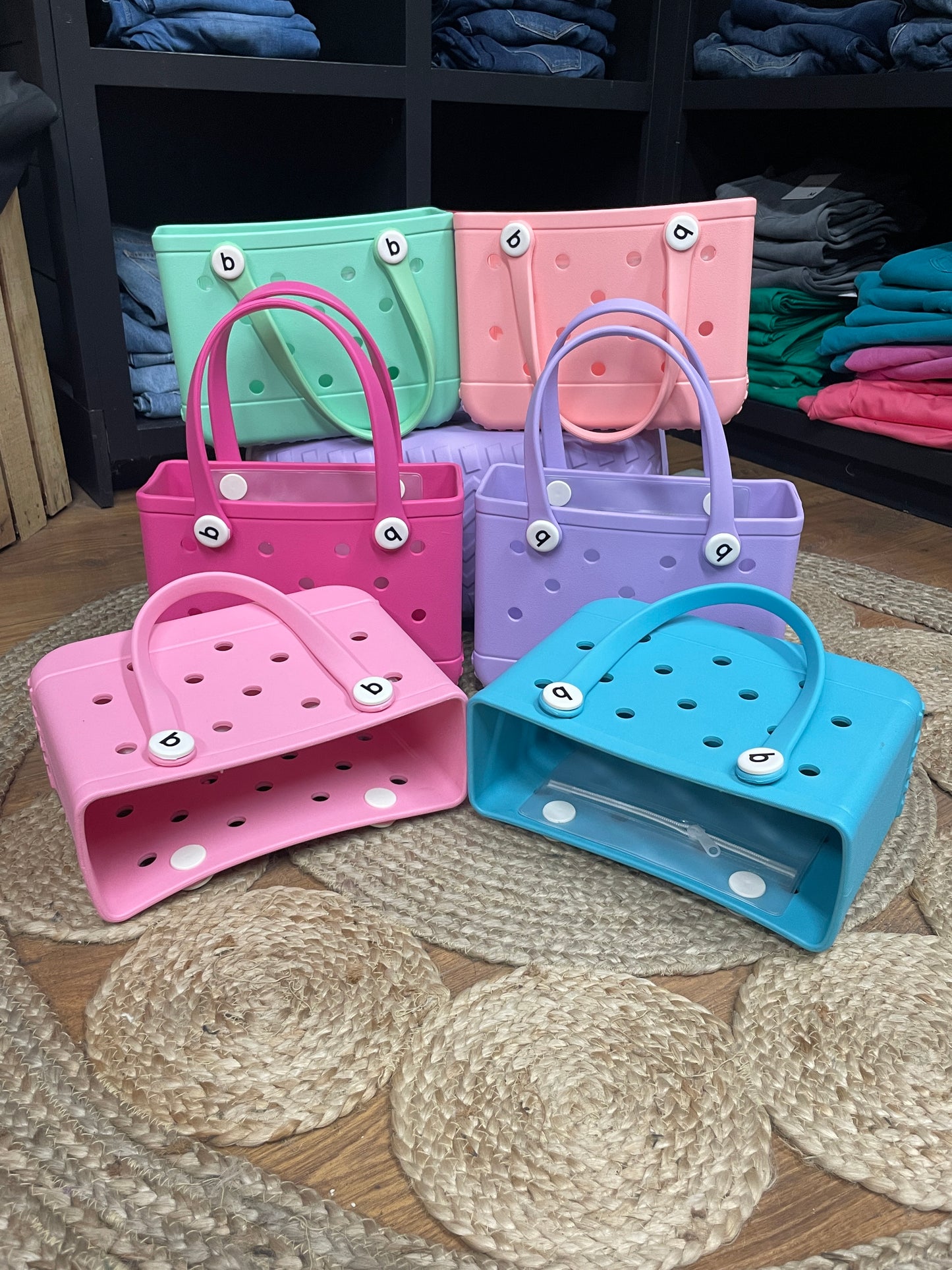 Small Bogg Bag – compact mint-colored EVA tote with handles
Small Bogg Bag in blush pink – front view on flat surface
Portability demo – small Bogg Bag styled over wrist or shoulder
Assorted Small Bogg Bags in fun color collection