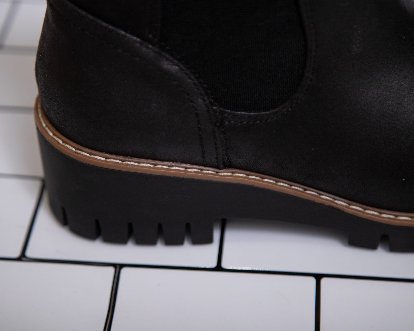 Women’s black ankle booties with lug sole and stretchy sides