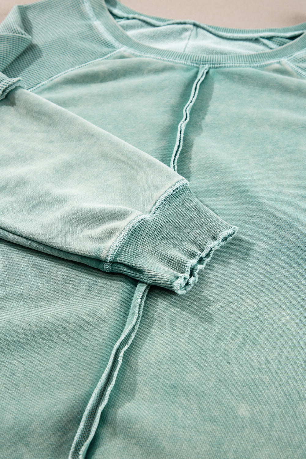 “Mineral blue waffle knit sweatshirt with patchwork raglan sleeves”
“Waffle texture sweatshirt with exposed seams – relaxed fit”
“Cozy patchwork raglan sleeve pullover in mineral blue”