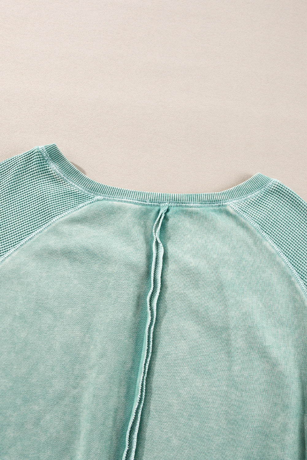 “Mineral blue waffle knit sweatshirt with patchwork raglan sleeves”
“Waffle texture sweatshirt with exposed seams – relaxed fit”
“Cozy patchwork raglan sleeve pullover in mineral blue”