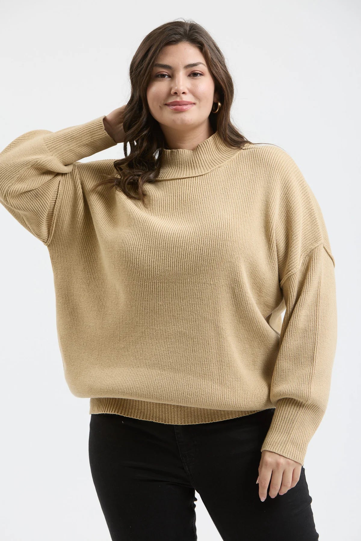Plus size ribbed sweater mock neck by Blu Pepper on hanger
Close-up of mock neck, ribbed texture, and seam detail
Model wearing Blu Pepper plus ribbed sweater styled with jeans