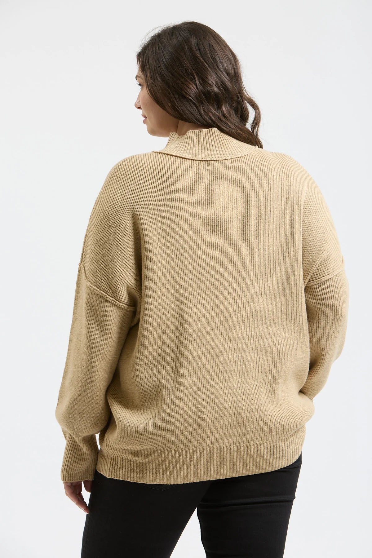 Plus size ribbed sweater mock neck by Blu Pepper on hanger
Close-up of mock neck, ribbed texture, and seam detail
Model wearing Blu Pepper plus ribbed sweater styled with jeans