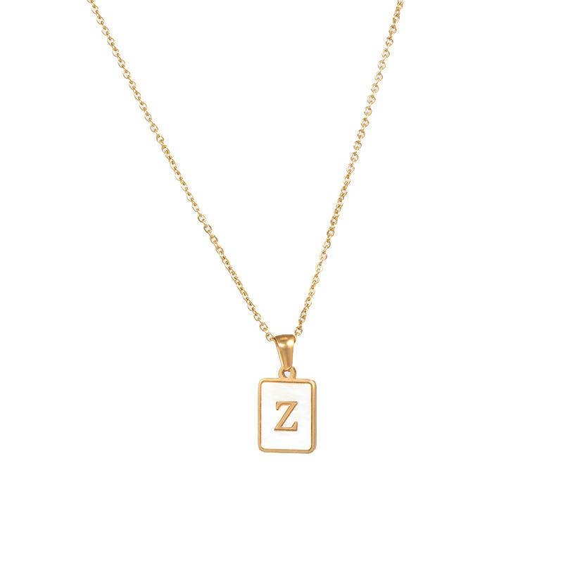 Square gold pendant necklace with initial “A” (or replace with example)
Close-up of gold square initial tag with polished finish and chain
Styled photo of initial necklace layered with other gold chains