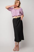 Floral printed poly crepe top tie-front in lavender color laid flat
Close-up of floral print and textured crepe fabric
Model wearing the Easel floral top in peri blue variant