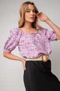 Floral printed poly crepe top tie-front in lavender color laid flat
Close-up of floral print and textured crepe fabric
Model wearing the Easel floral top in peri blue variant