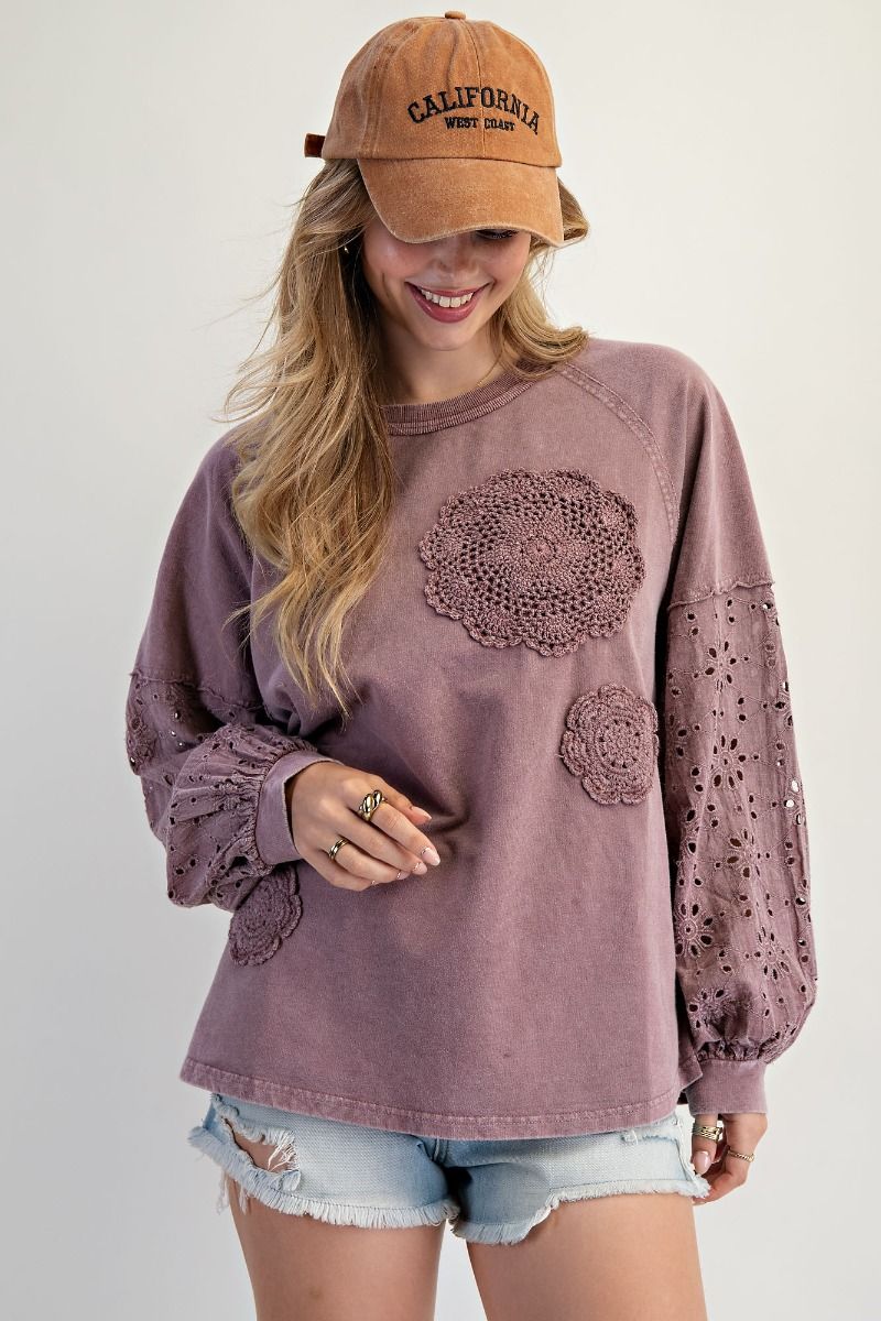 “Lightweight mineral-washed French terry pullover with eyelet lace raglan sleeves and crochet floral detail”
“Soft round-neck eyelet lace pullover top”