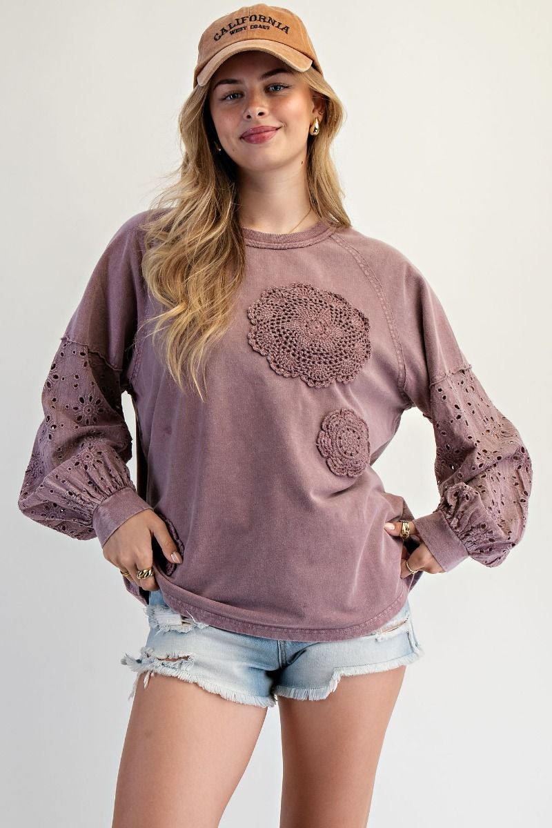 “Lightweight mineral-washed French terry pullover with eyelet lace raglan sleeves and crochet floral detail”
“Soft round-neck eyelet lace pullover top”