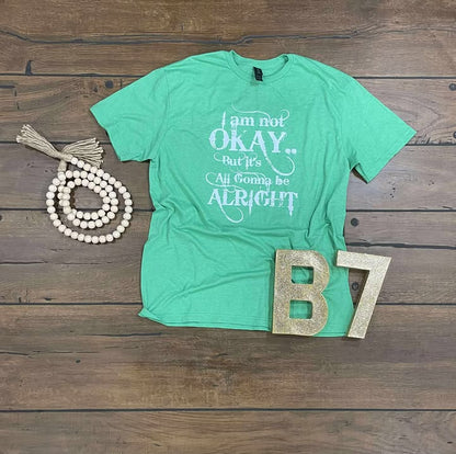 “I Am Not Okay But It’s All Gonna Be Alright” Graphic Tee – Uplifting & Relatable Everyday Comfort 🌤️