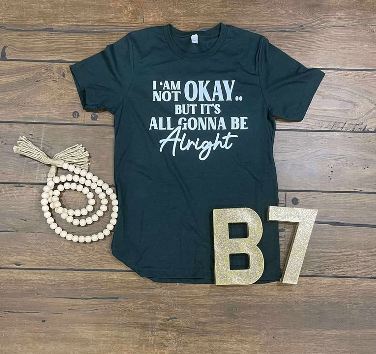 “I Am Not Okay But It’s All Gonna Be Alright” Graphic Tee – Uplifting & Relatable Everyday Comfort 🌤️