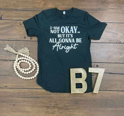 “I Am Not Okay But It’s All Gonna Be Alright” Graphic Tee – Uplifting & Relatable Everyday Comfort 🌤️
