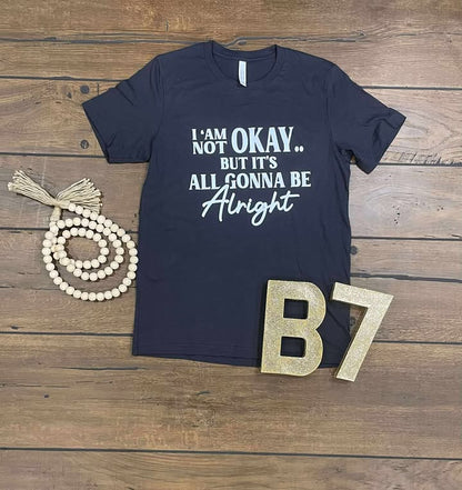 “I Am Not Okay But It’s All Gonna Be Alright” Graphic Tee – Uplifting & Relatable Everyday Comfort 🌤️