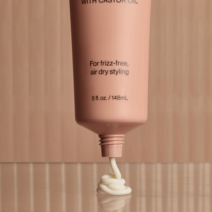 Lifestyle image of KITSCH Smoothing Air Dry Cream next to hairbrush and accessories