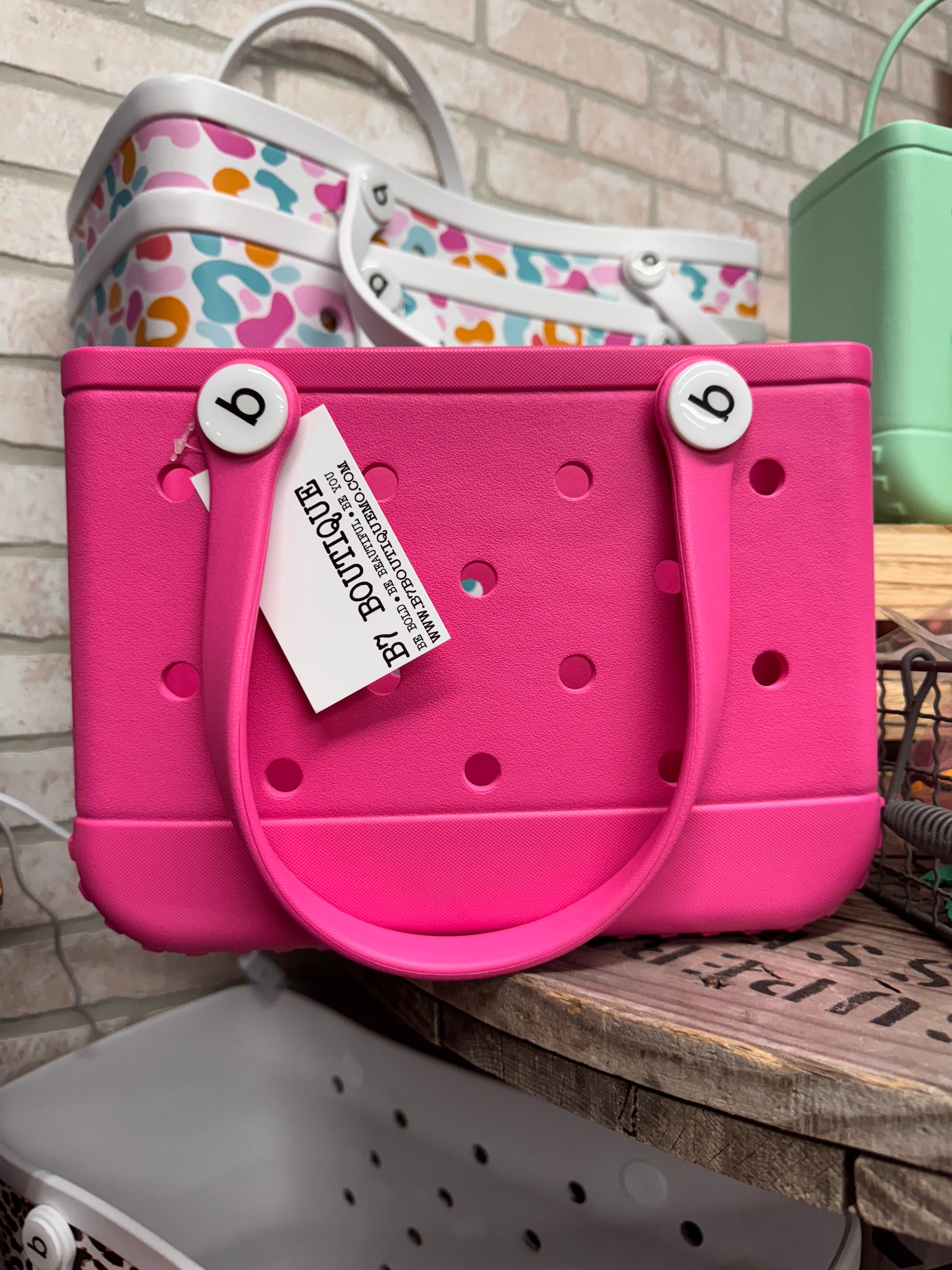 Small Bogg Bag – compact mint-colored EVA tote with handles

Small Bogg Bag in blush pink – front view on flat surface

Portability demo – small Bogg Bag styled over wrist or shoulder

Assorted Small Bogg Bags in fun color collection