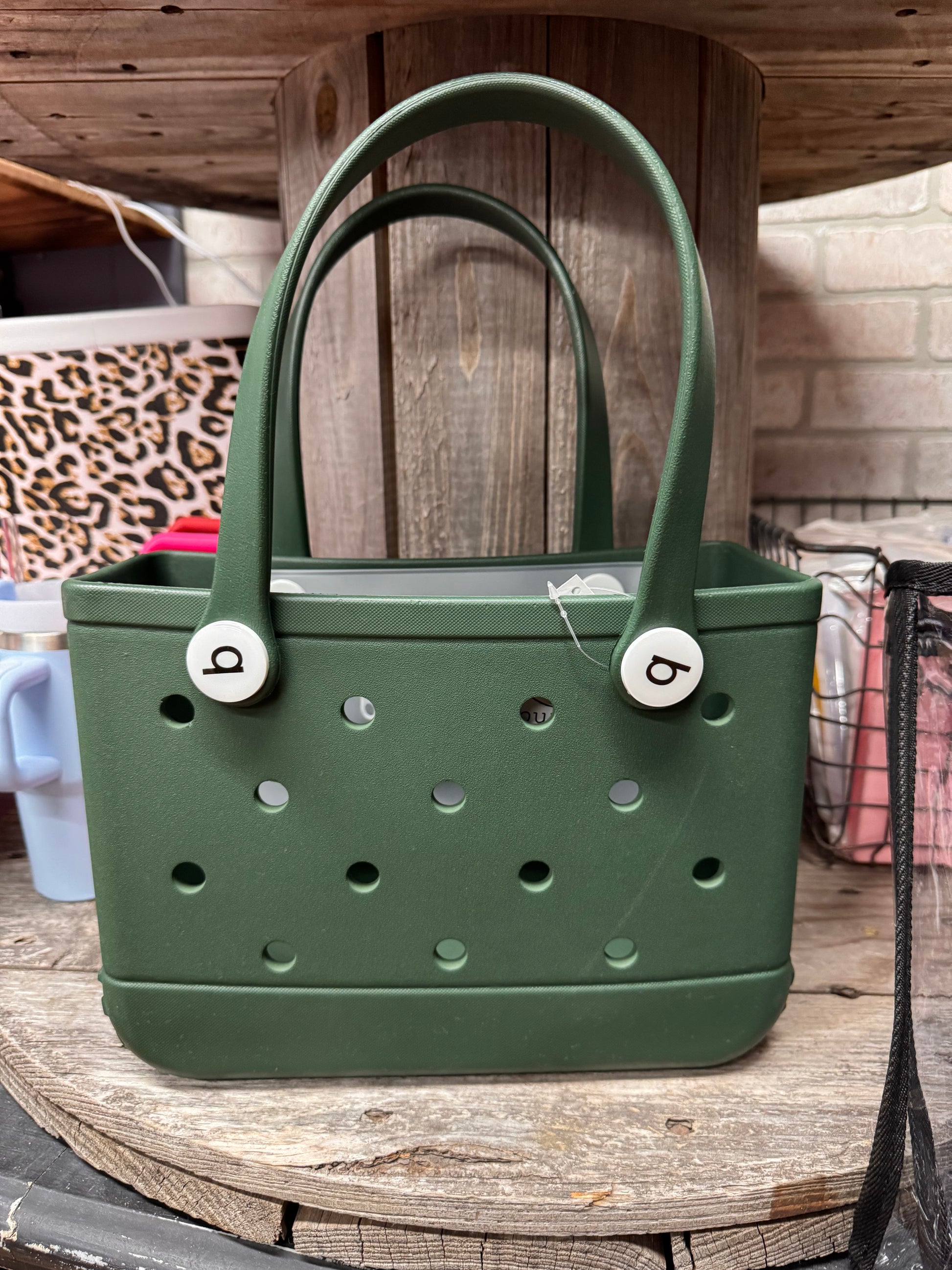 Small Bogg Bag – compact mint-colored EVA tote with handles

Small Bogg Bag in blush pink – front view on flat surface

Portability demo – small Bogg Bag styled over wrist or shoulder

Assorted Small Bogg Bags in fun color collection