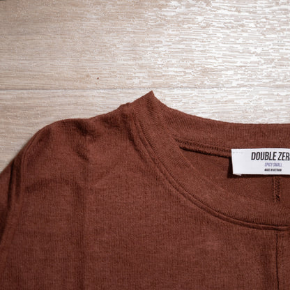 Brown shirt with a visible brand label on a wooden surface