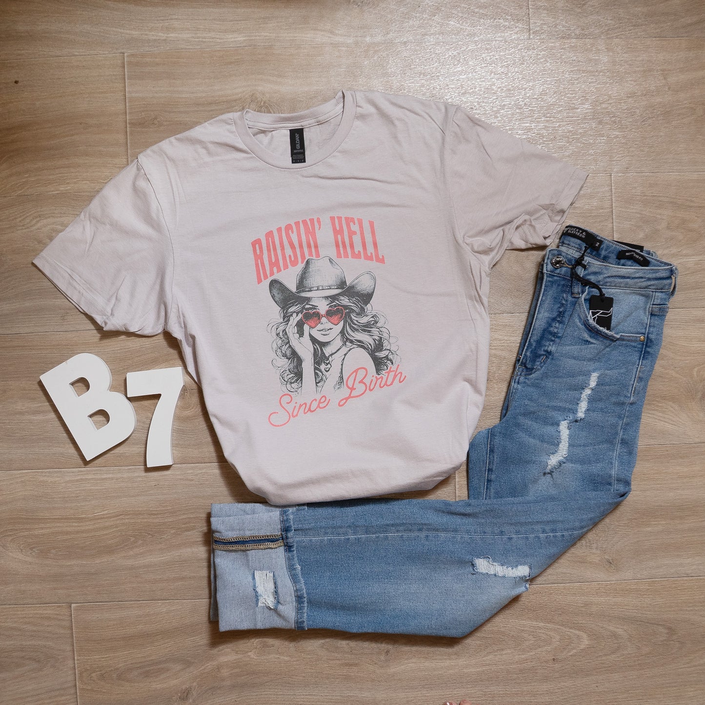 Raisin’ Hell Since Birth Graphic Tee – Western Cowgirl T-Shirt with Heart Sunglasses