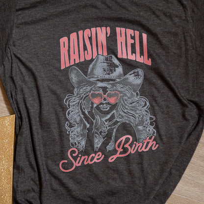 Raisin’ Hell Since Birth Graphic Tee – Western Cowgirl T-Shirt with Heart Sunglasses