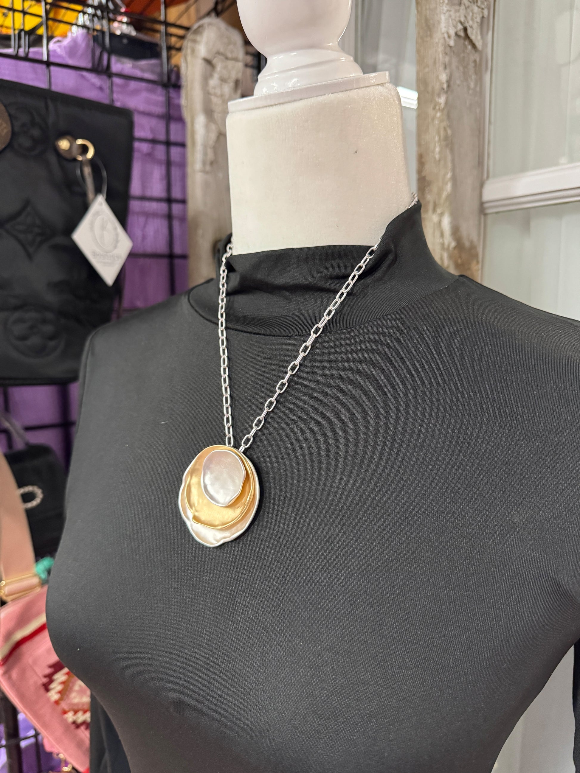 “Layered mixed metal gold and silver necklace”

“Dish Me Up mixed metal layered chain from B7 Boutique”

“Two-tone chain necklace with gold accents and silver links”
