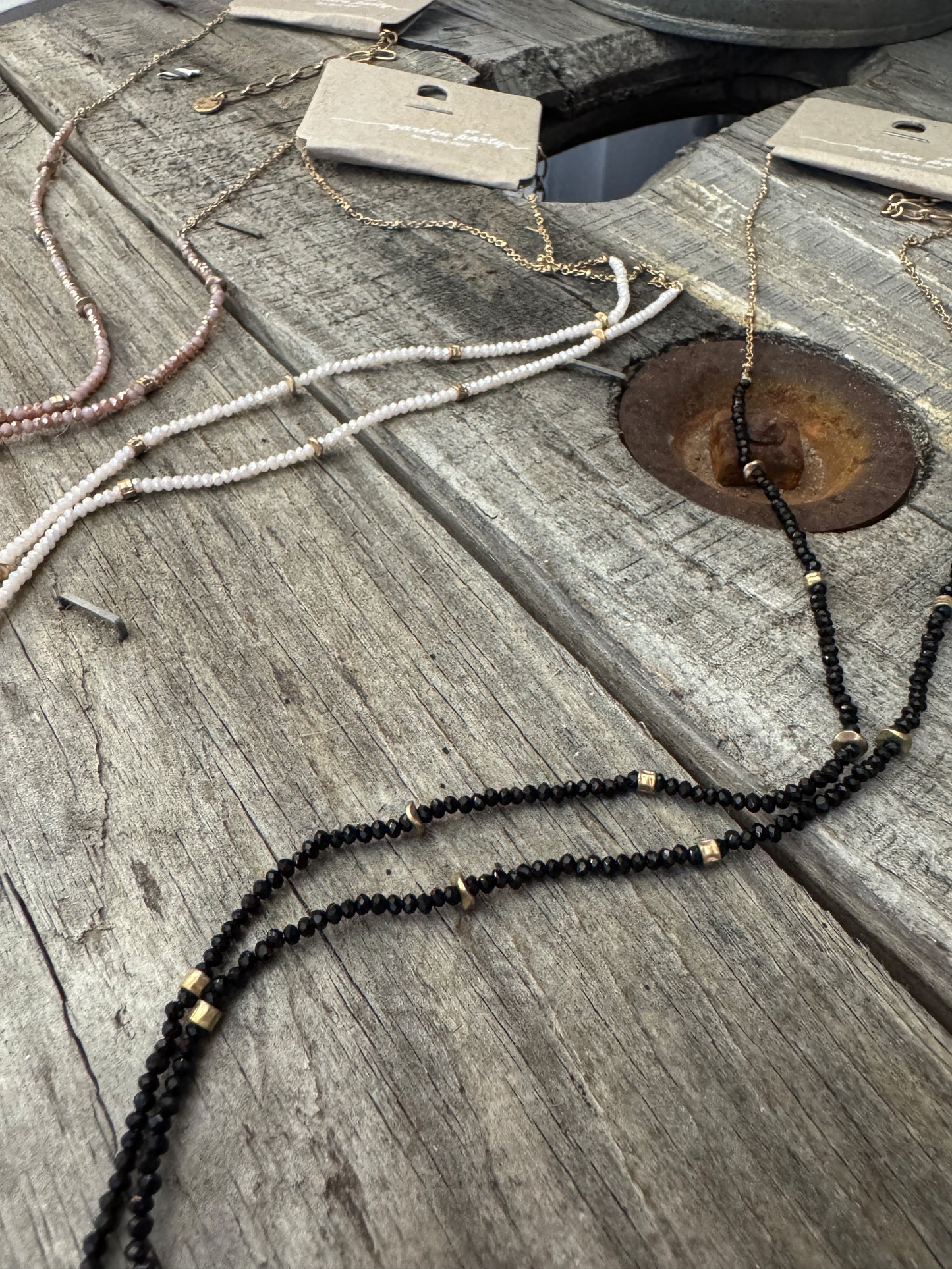 “Dainty Days beaded necklace in pink”

“Elegant black beaded chain necklace from B7 Boutique”

“White subtle beaded necklace, perfect for layering”