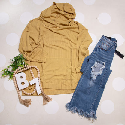 Flat Lay of Mustard Stay Cozy Soft Textured Hoodie by Stylive with Distressed Jeans and Boho Boutique Decor