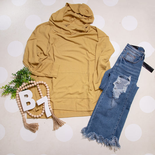 Flat Lay of Mustard Stay Cozy Soft Textured Hoodie by Stylive with Distressed Jeans and Boho Boutique Decor