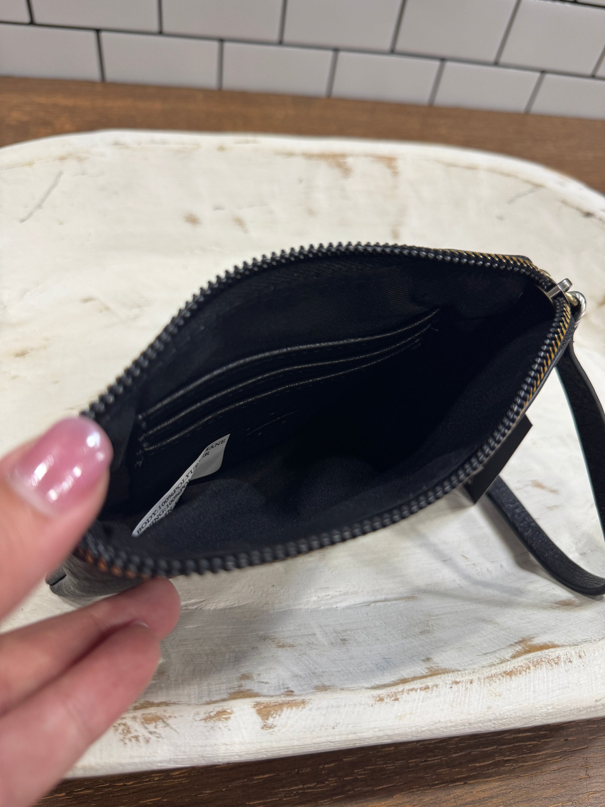 Minimalist black clutch bag with zipper and strap