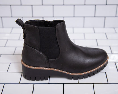 Women’s black ankle booties with lug sole and stretchy sides