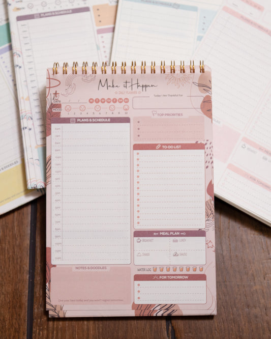 Spiral-bound planner with floral design on a wooden surface