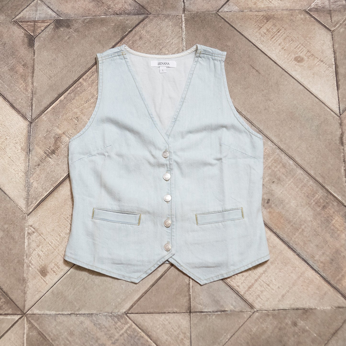 Light blue vest on a tiled floor