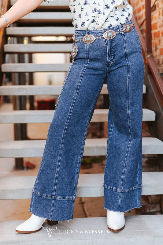 mid wash wide leg jeans with exposed seam detail and raw hem