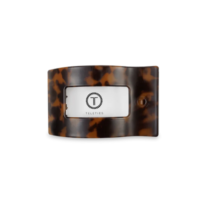 “Small flat TELETIES hair clip on white background”

“No-snag claw clip for thin to medium hair”

“Flat-back TELETIES clip perfect for driving or lounging”