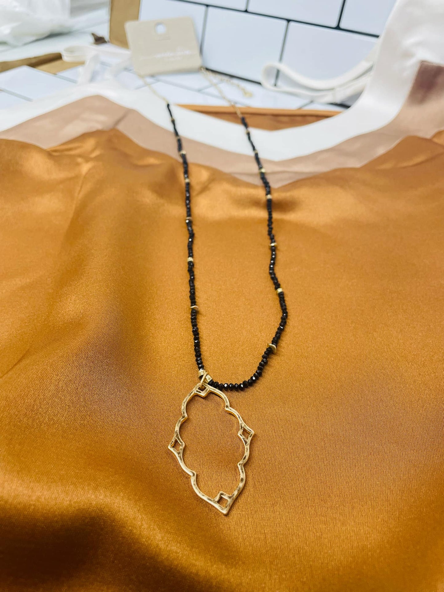 “Dainty Days beaded necklace in pink”

“Elegant black beaded chain necklace from B7 Boutique”

“White subtle beaded necklace, perfect for layering”
