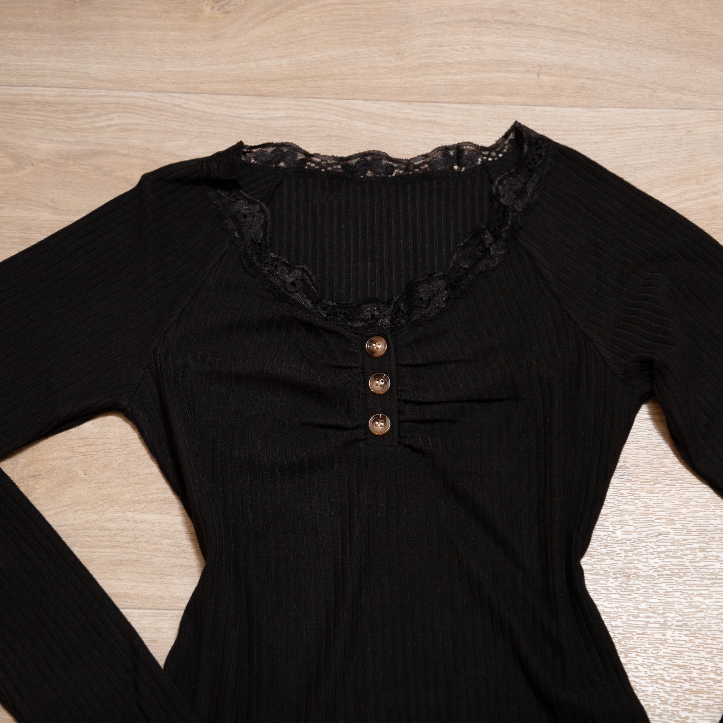 Black ribbed long sleeve henley top with lace neckline and button detail