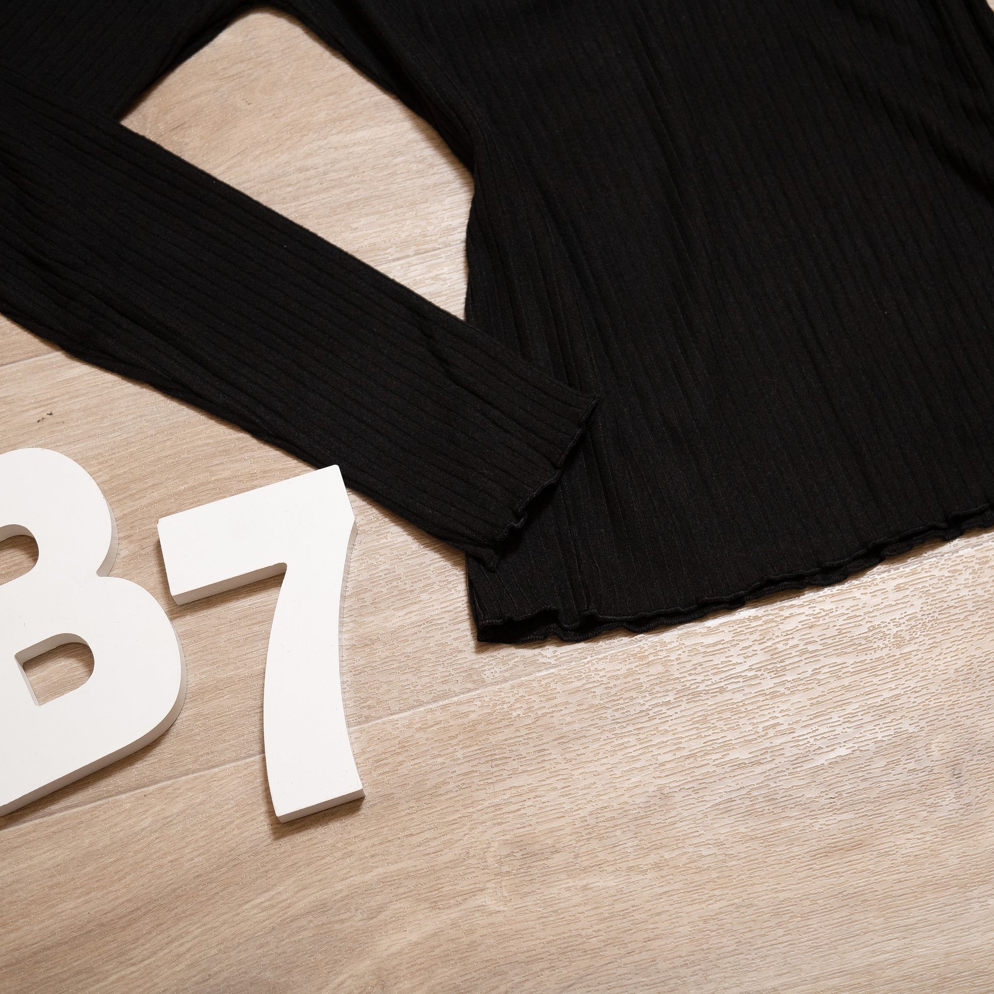 Black ribbed long sleeve henley top with lace neckline and button detail