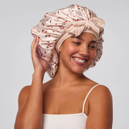 Woman wearing a patterned satin headband against a plain background