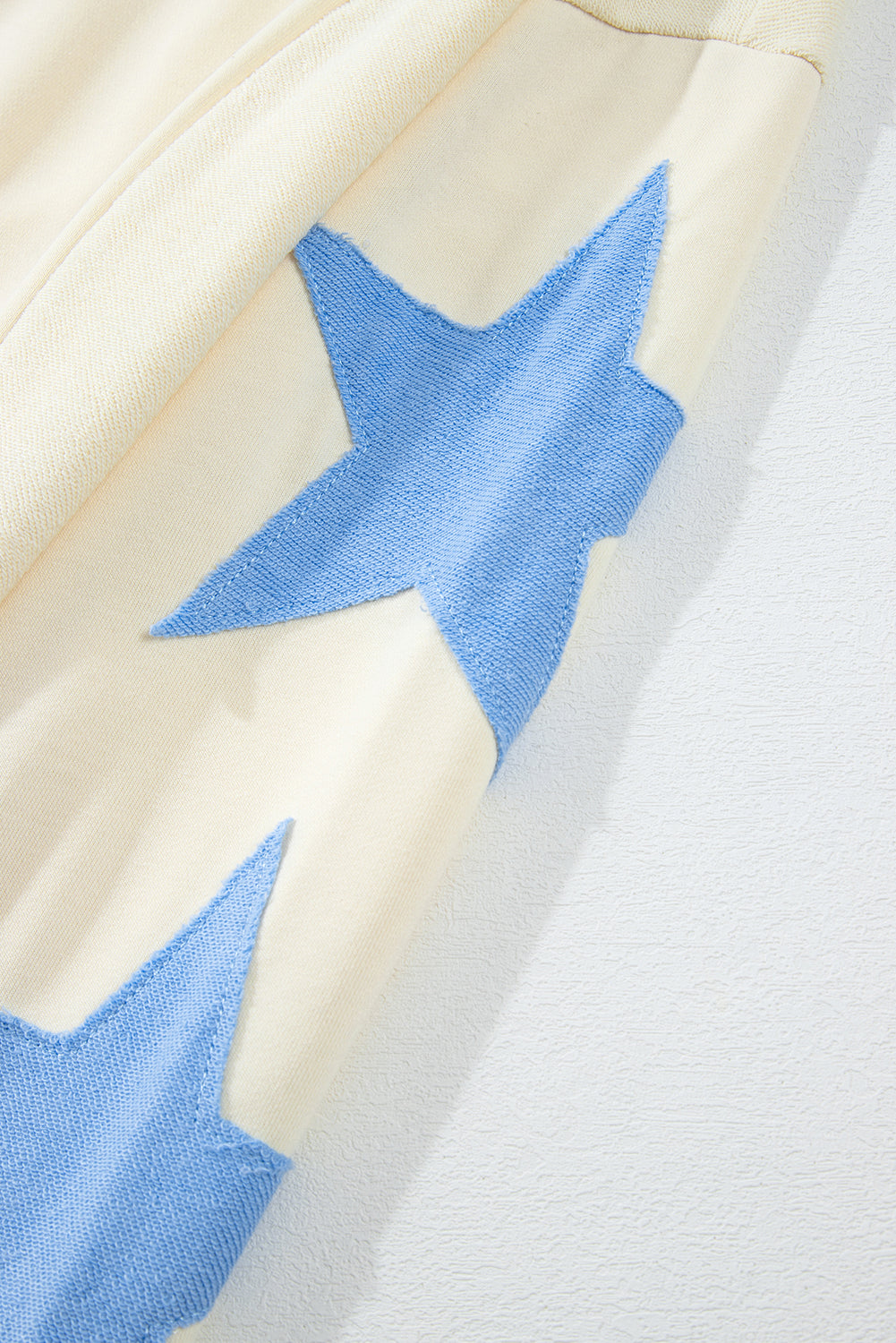 Beige Star Contrast Patchwork Long-Sleeve Top – Relaxed Fit with Exposed Seams