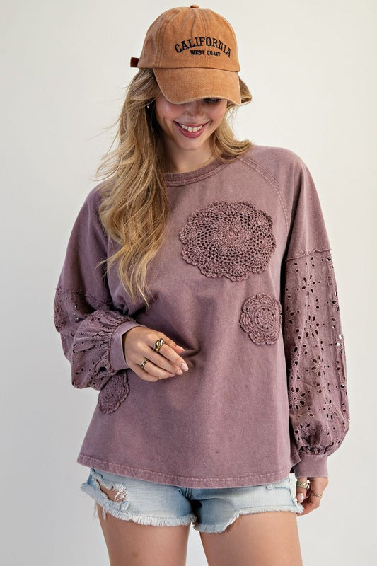 “Lightweight mineral-washed French terry pullover with eyelet lace raglan sleeves and crochet floral detail”
“Soft round-neck eyelet lace pullover top”