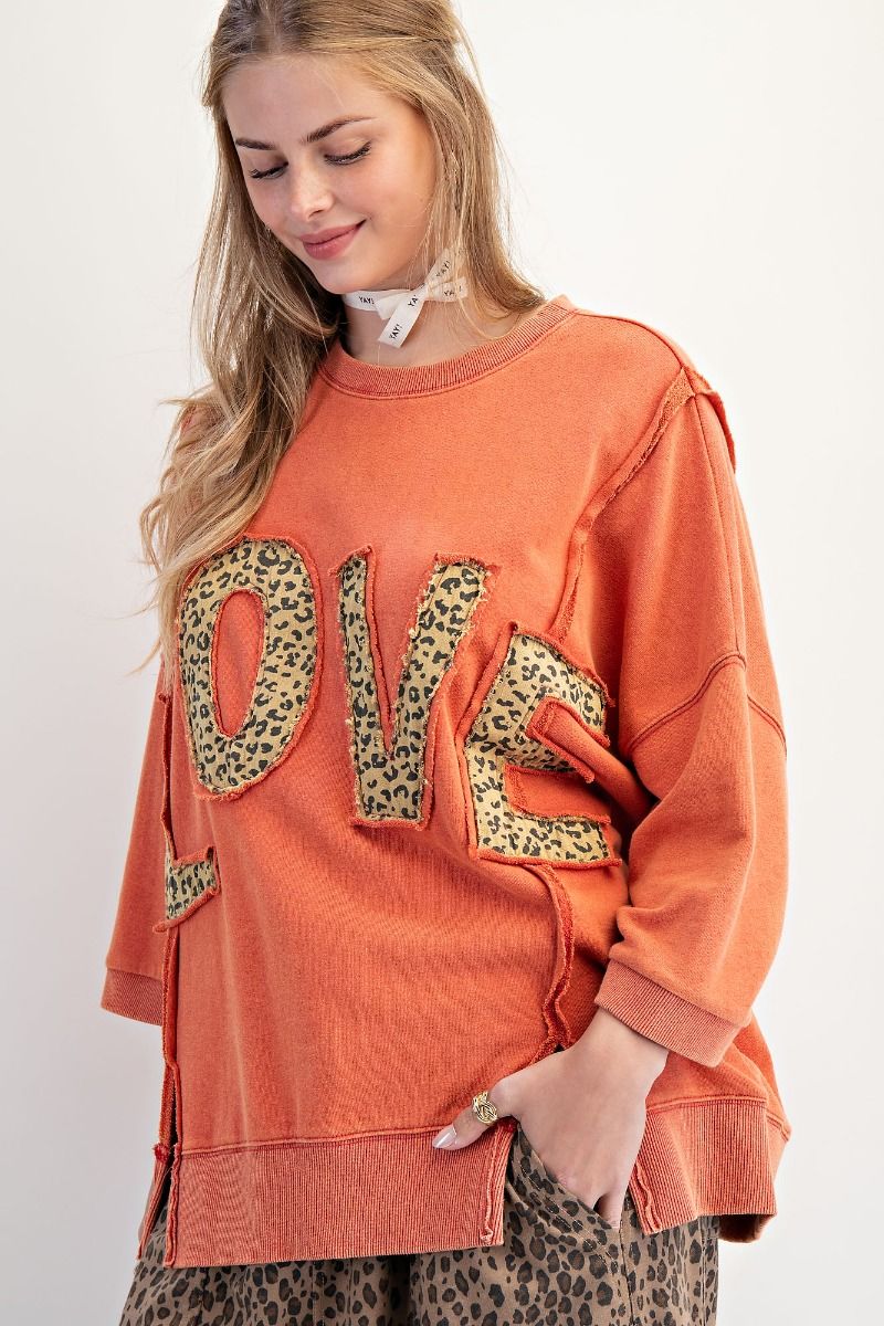 Soft relaxed fit sweatshirt with bold LOVE patch