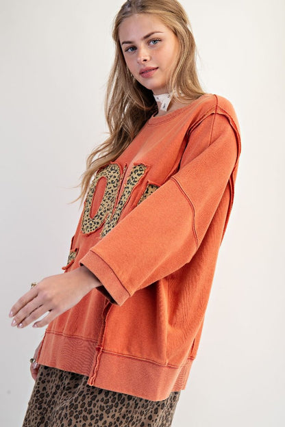 Soft relaxed fit sweatshirt with bold LOVE patch